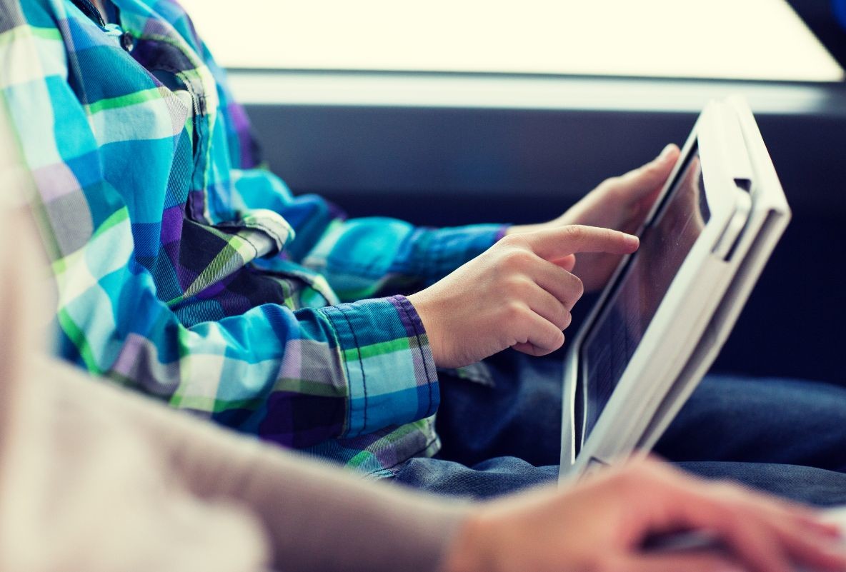 close up of boy with tablet pc in travel bus PDRZVS