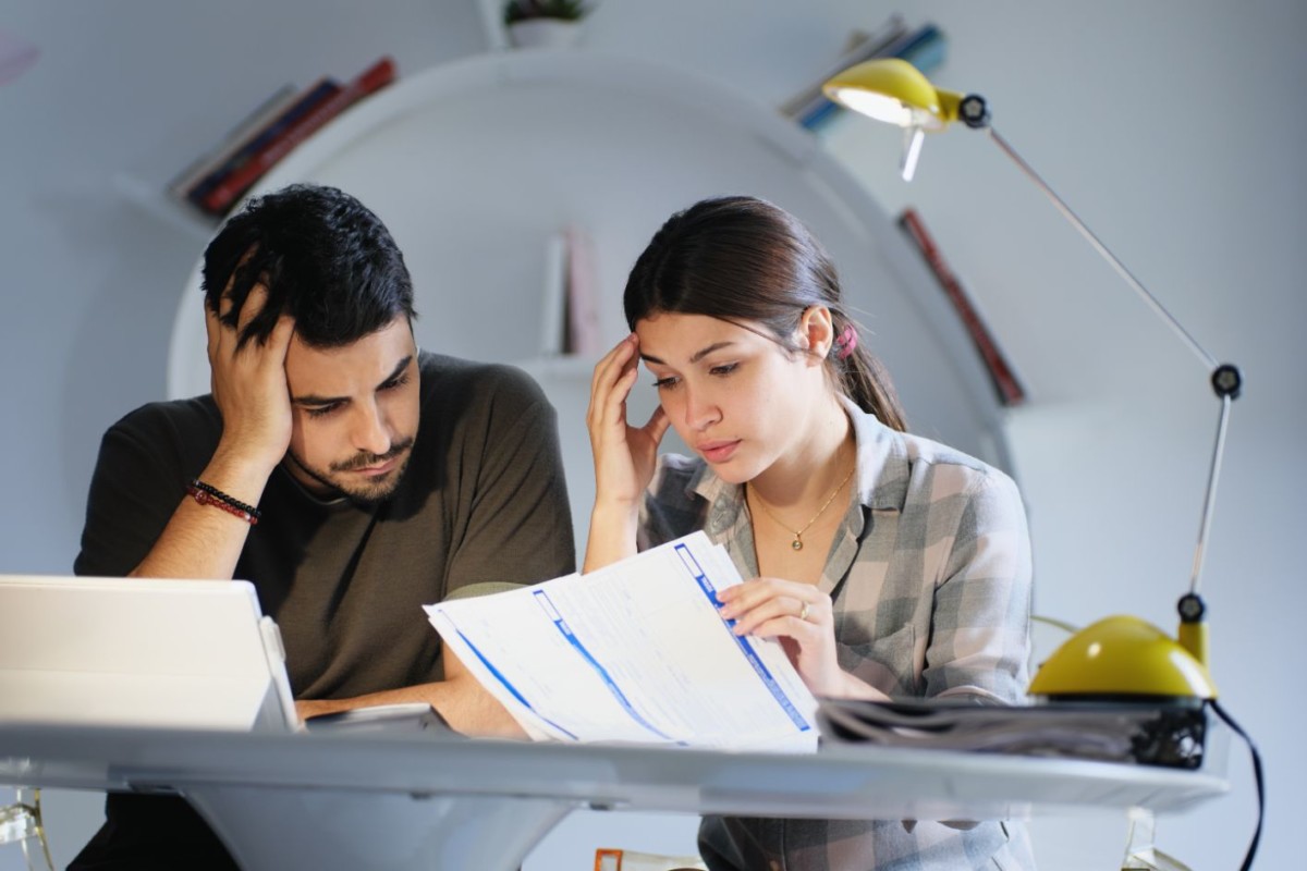 man and woman worried for taxes and family budget YQMFB