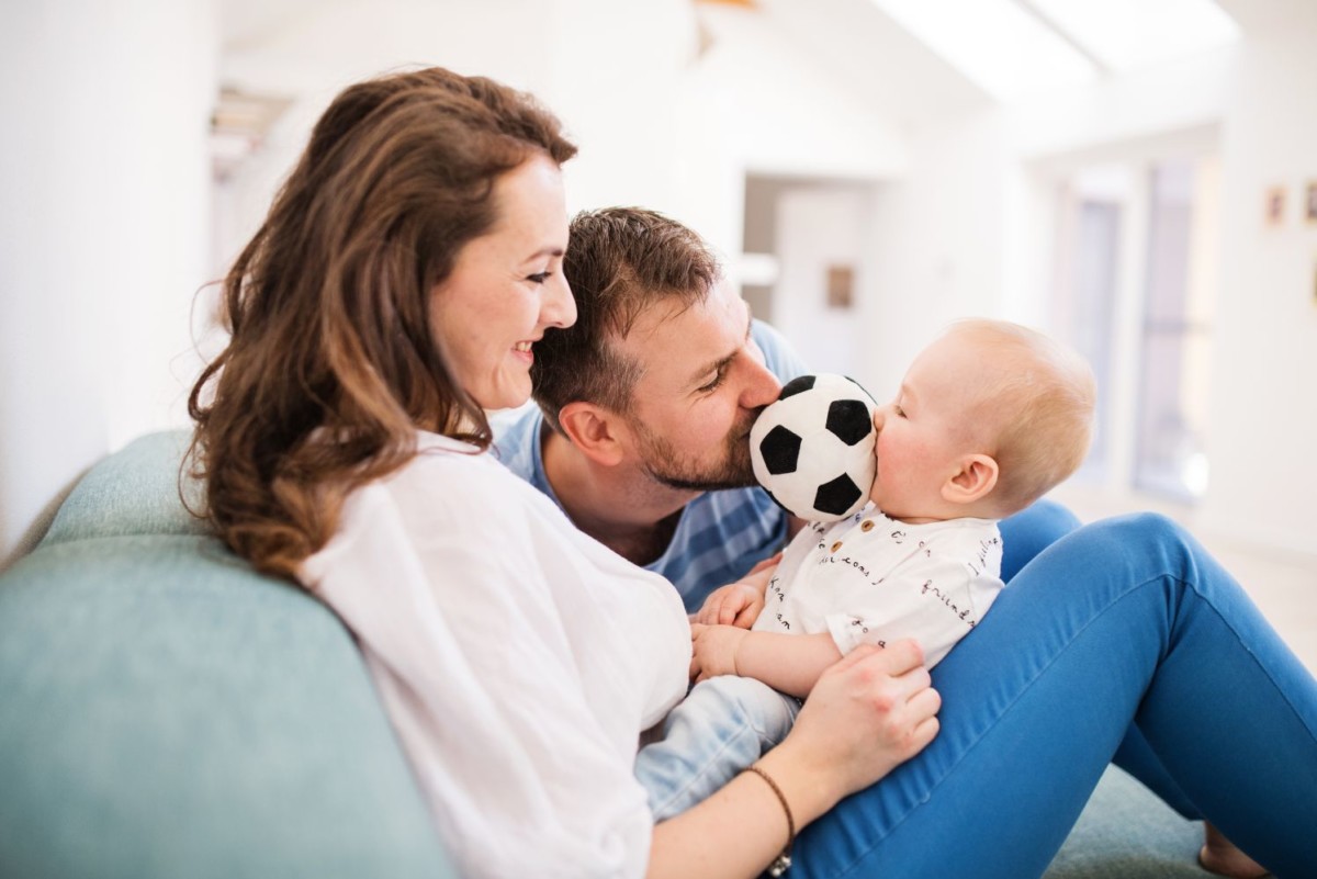 young family with a baby boy at home sitting on VFZLY