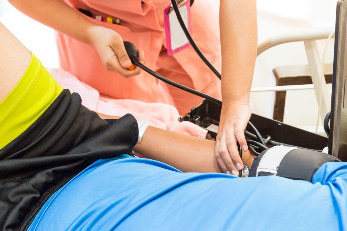 closeup of nurse taking patient blood pressure PMTY