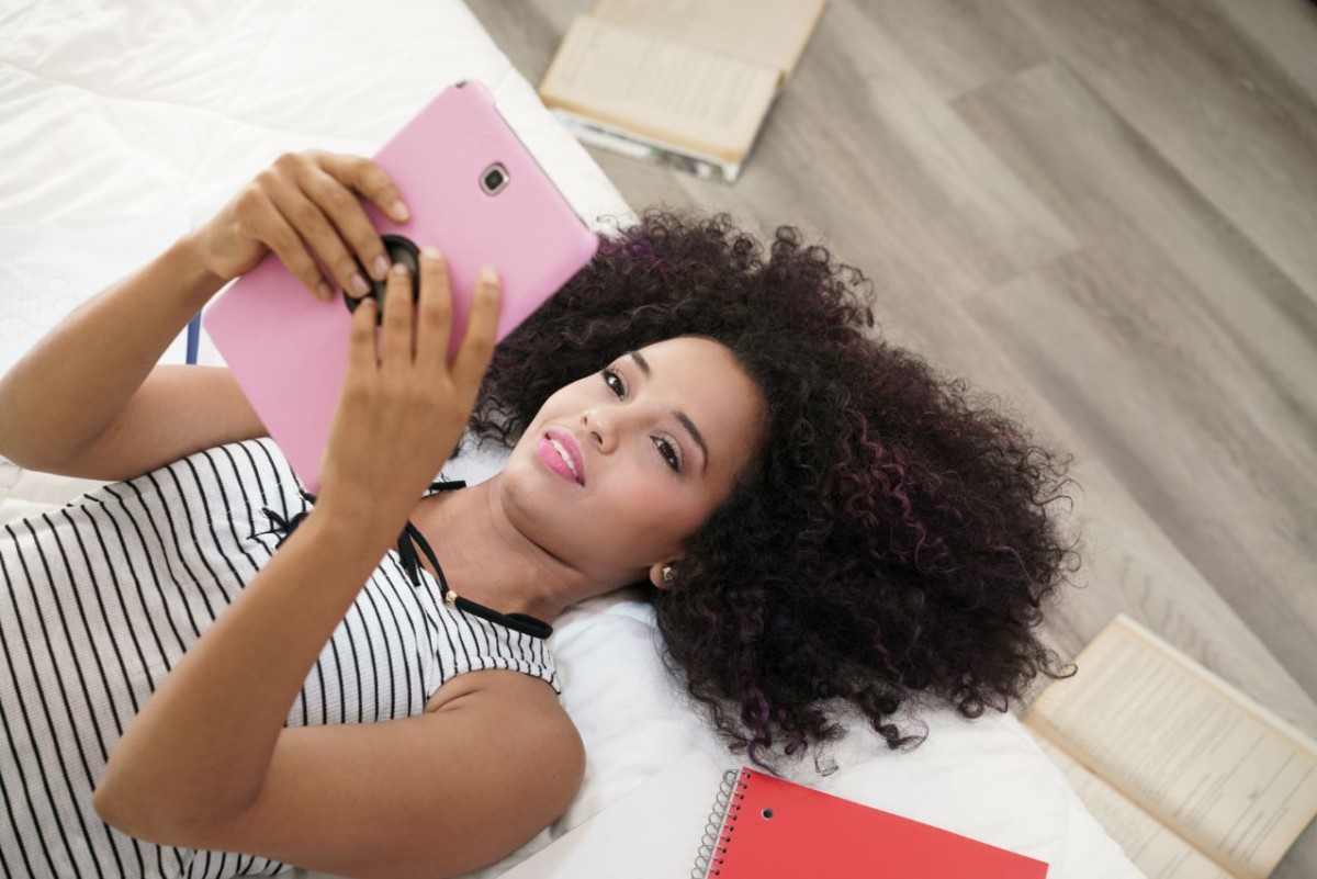 hispanic girl using digital tablet for school BAYJZR