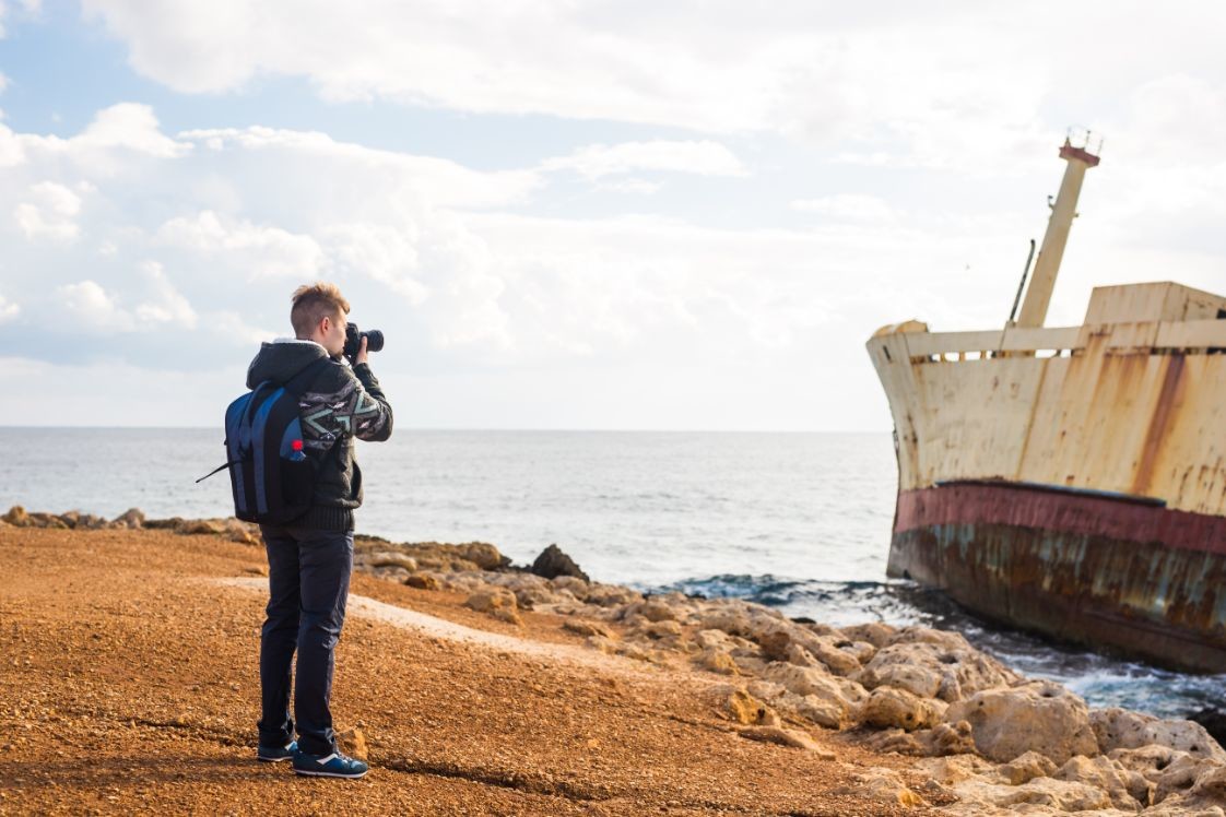 young photographer on the beach traveler PDS