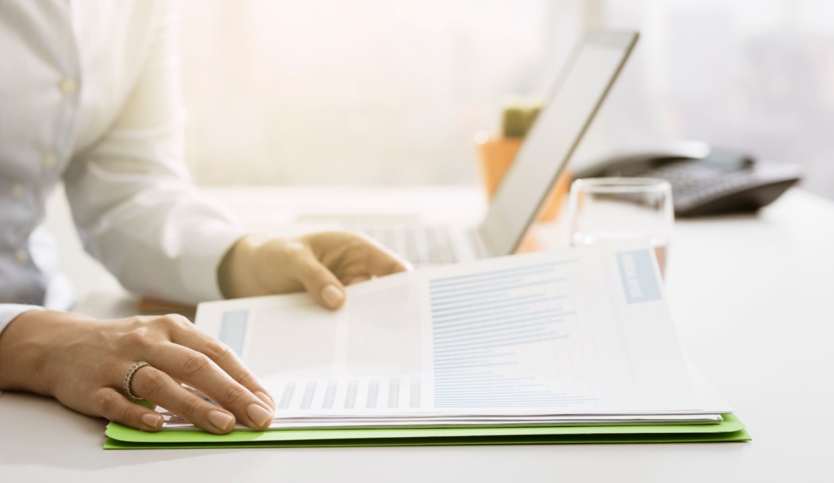 businesswoman checking financial reports and MES