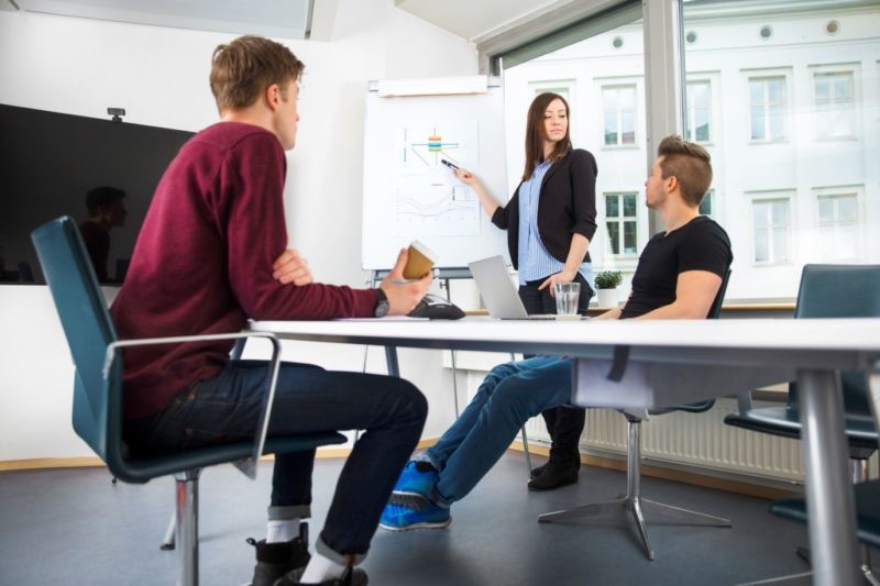 businesswoman explaining graph to coworker