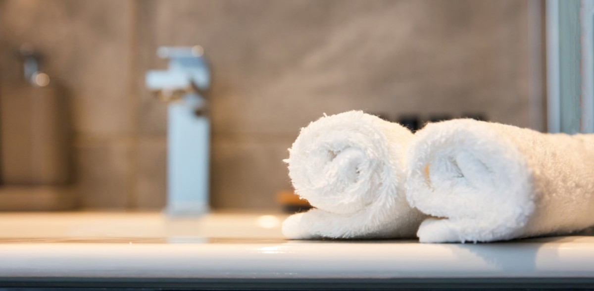 luxury bathroom sink and white towels closeup ABNSZJ