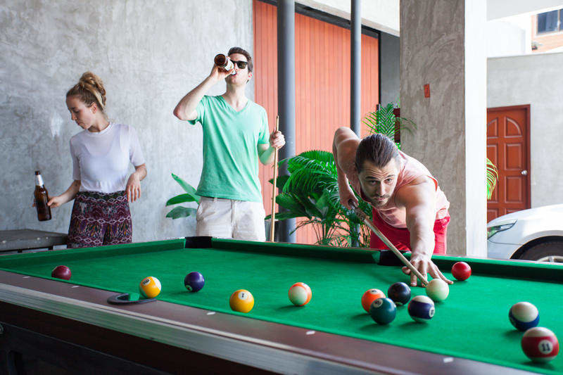 Backpackers Playing Pool