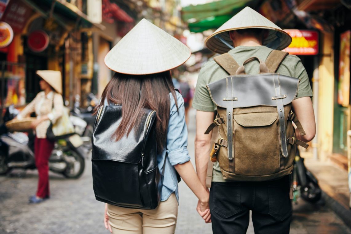 back view of tourist with backpack exploring the c ZQFUR