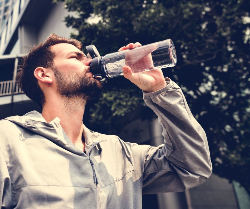 man drinking out of a water bottle PNRWJH