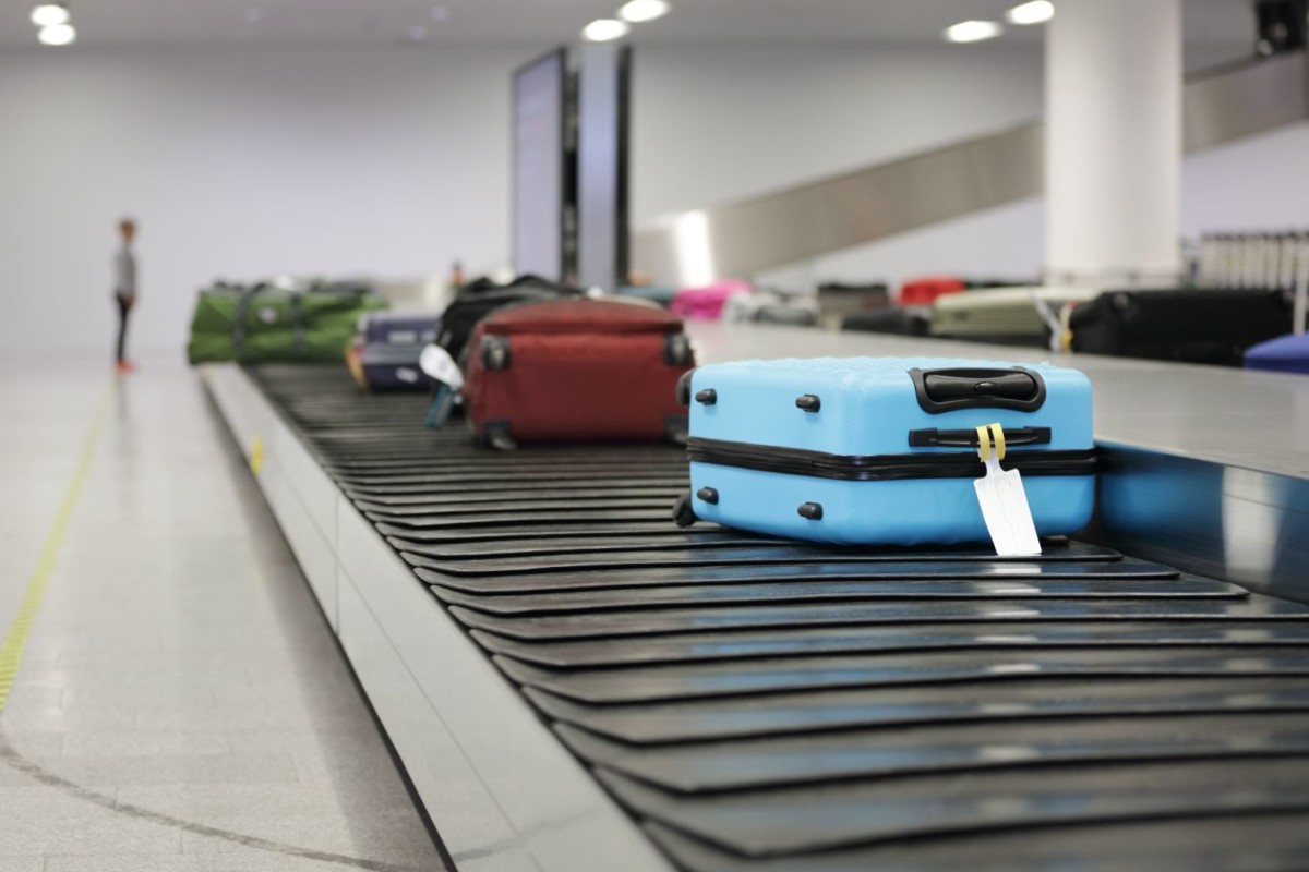 suitcase or luggage on conveyor belt in the airpor PLDJWV