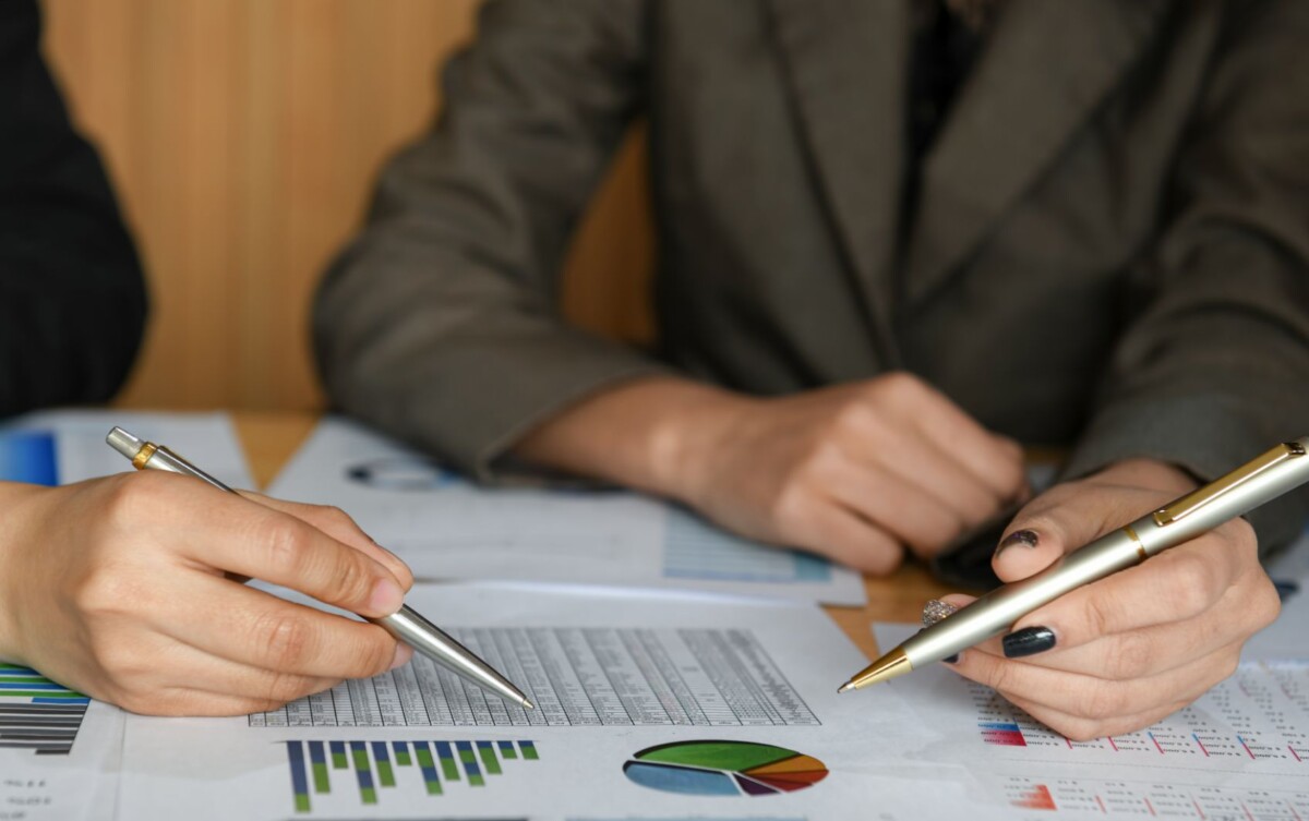 female accountant team is calculating the budget t FGSVW