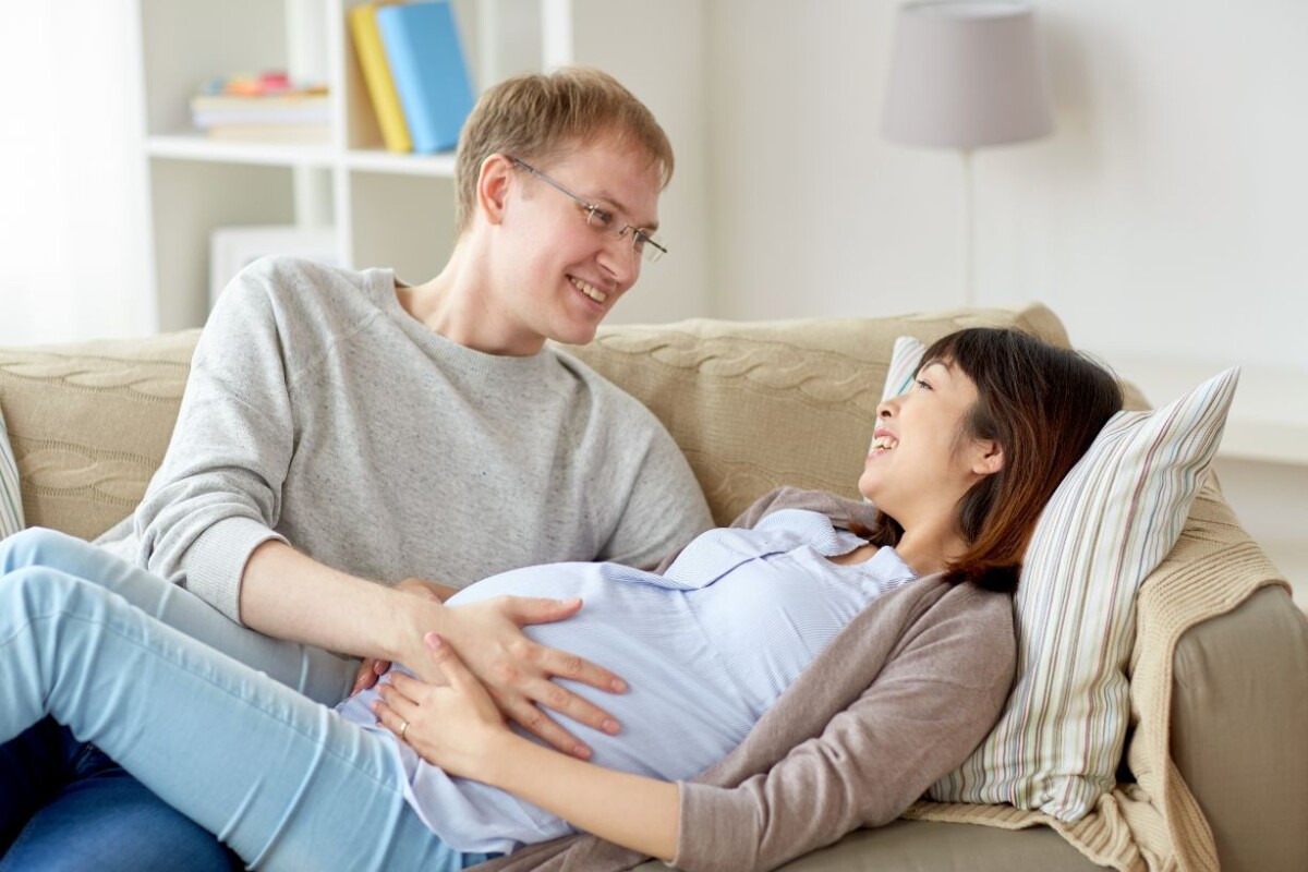 happy pregnant wife with husband at home PFDECY