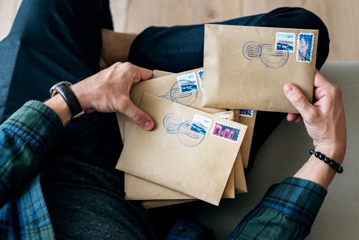 aerial view of a man sorting an envelope pewma