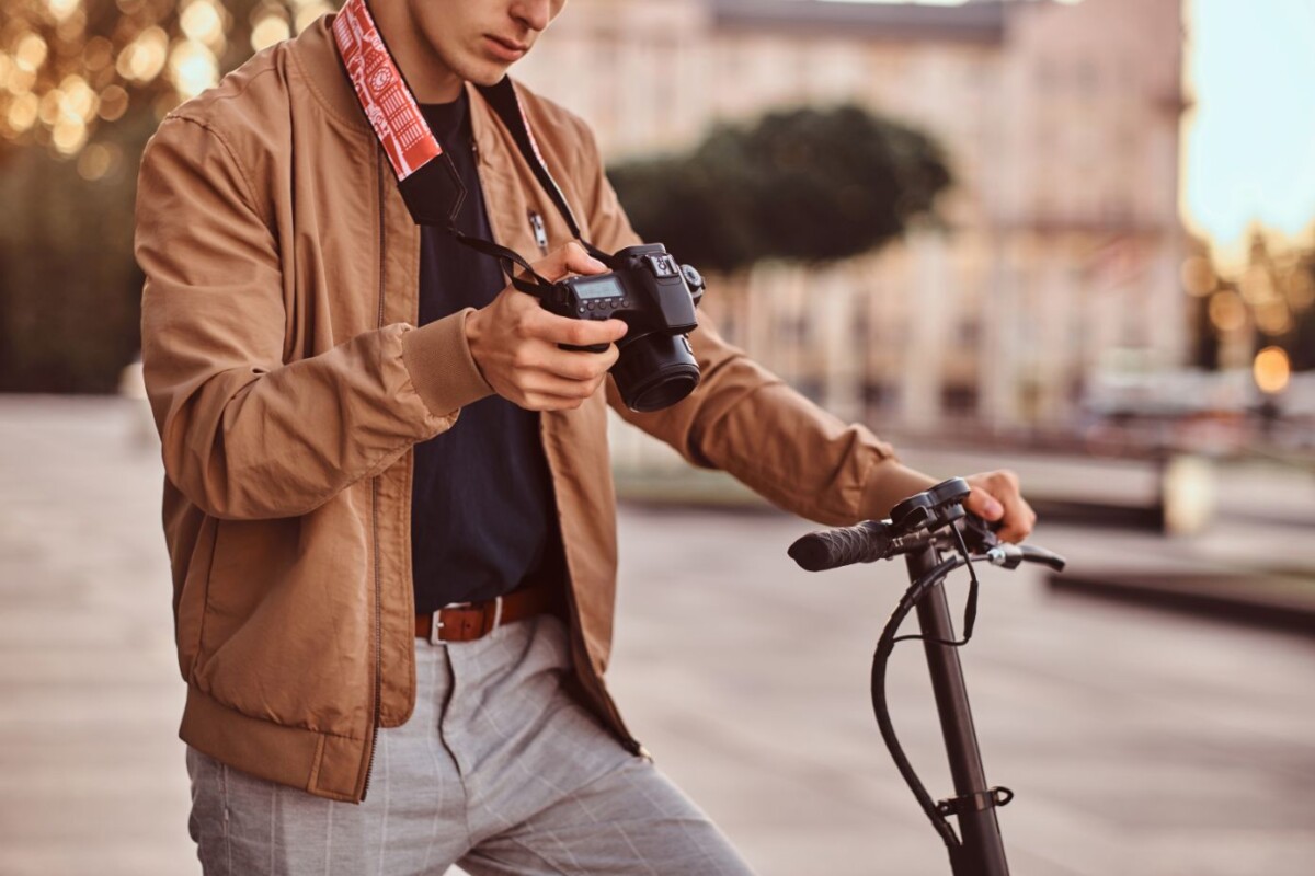 man with scooter and proto camera is watching phot ujg