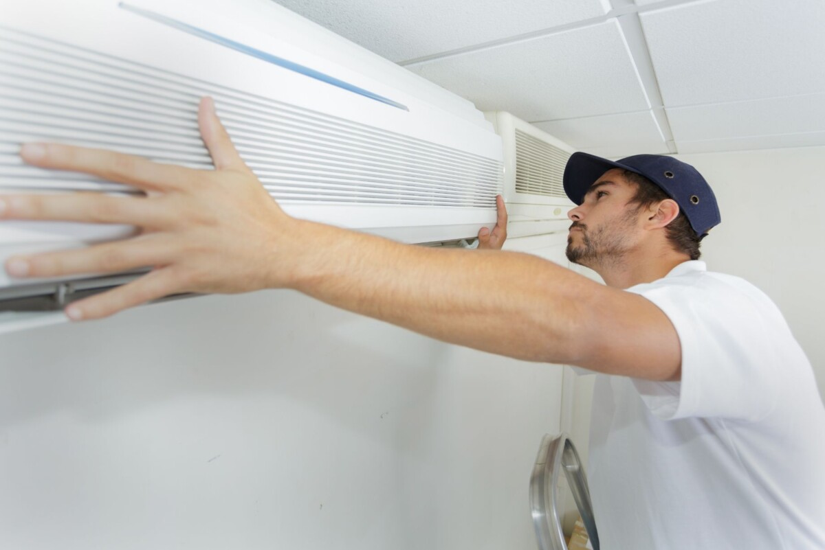 tech guy carefully installing new ac pawpx