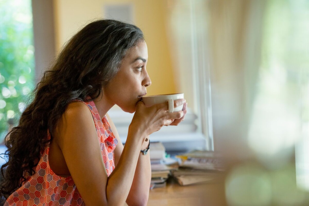 a woman sitting alone in a cafe having coffee vrwsbe