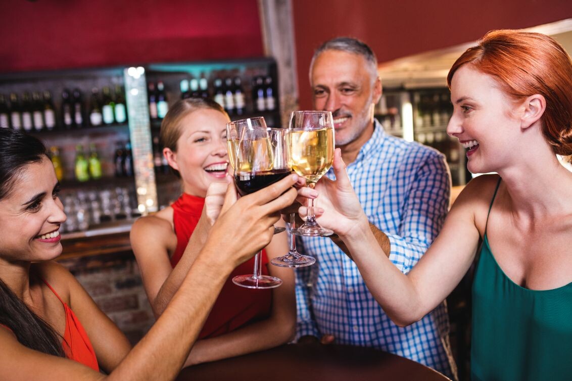 friends toasting wine glass in night club afy