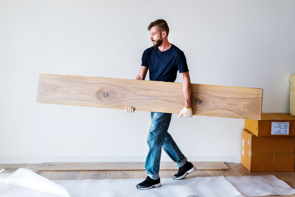 carpenter man installing wooden floor abvrf