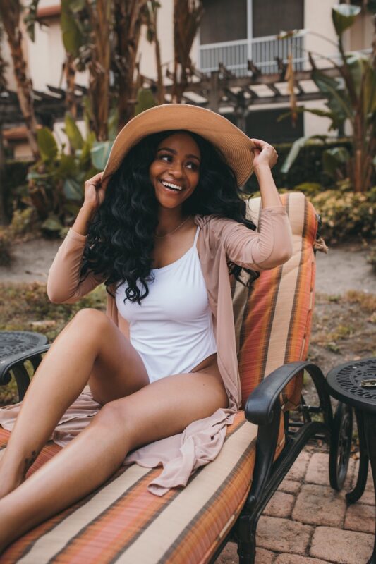 girl holding hat smiling