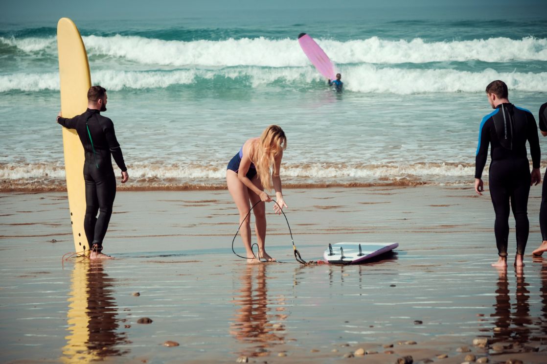 surfer friends on a beach with a surfing boards PBPQRK