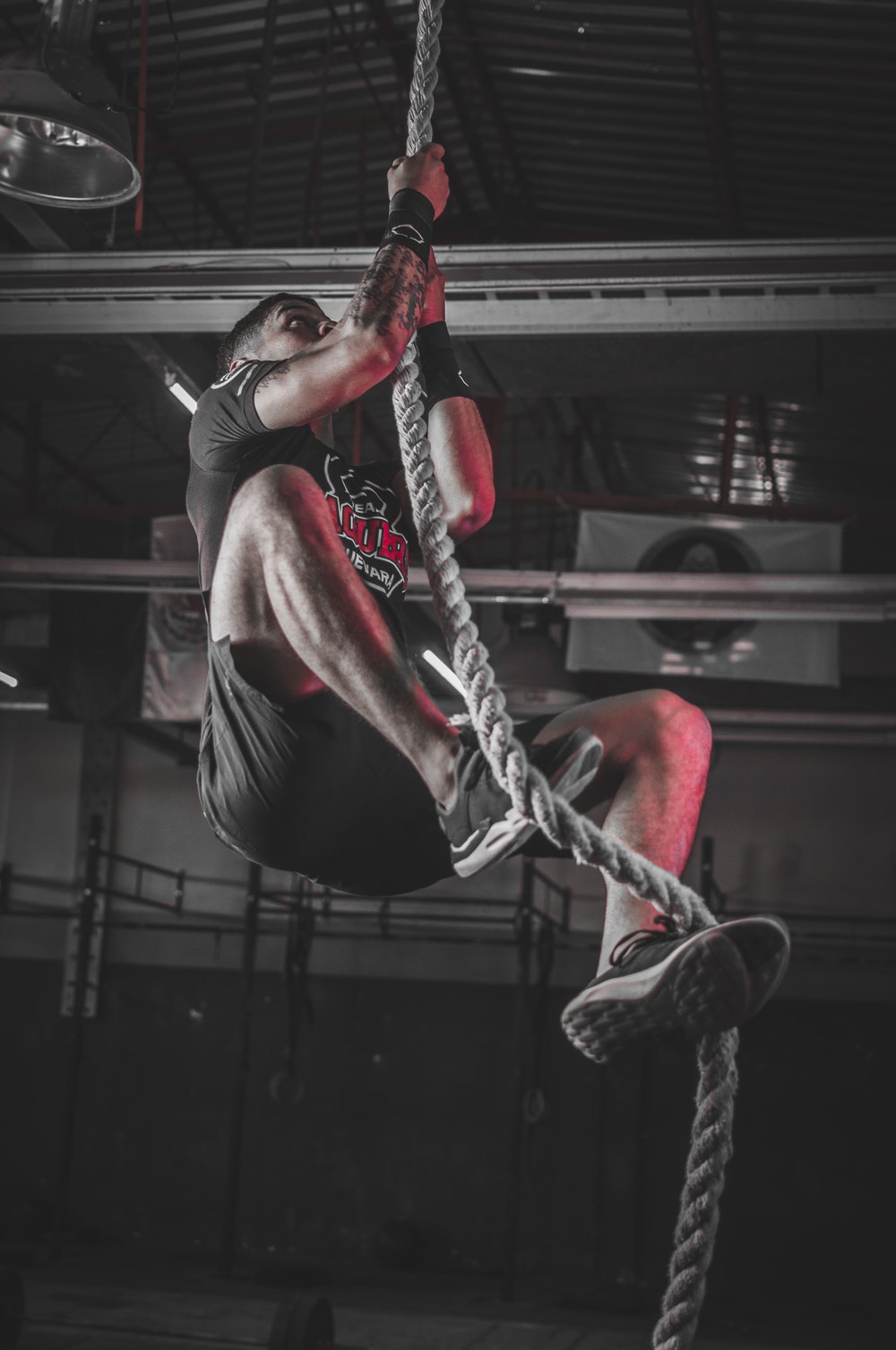 man climbing on rope