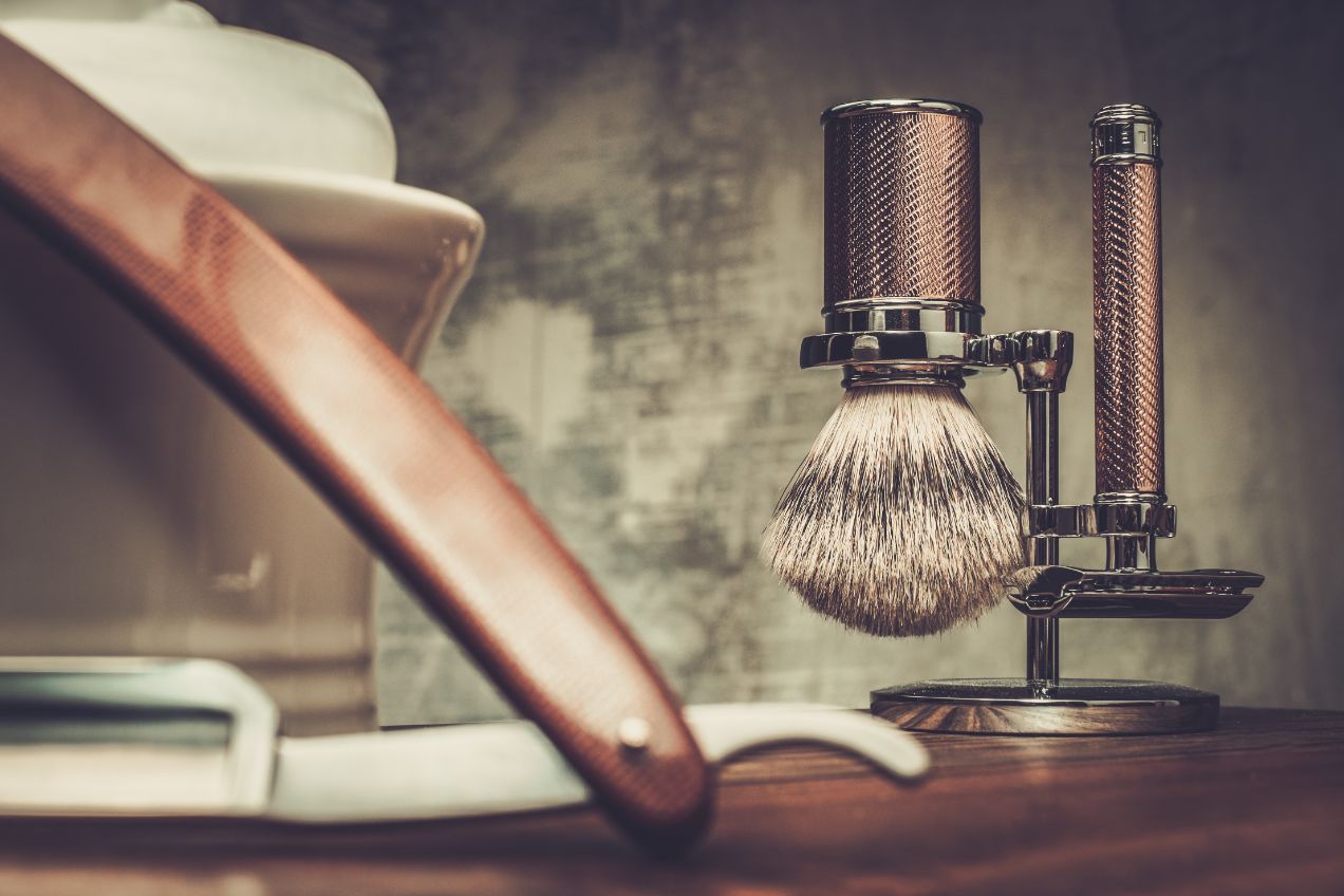 shaving razors and bowl with foam on wooden backgr PATNXAA