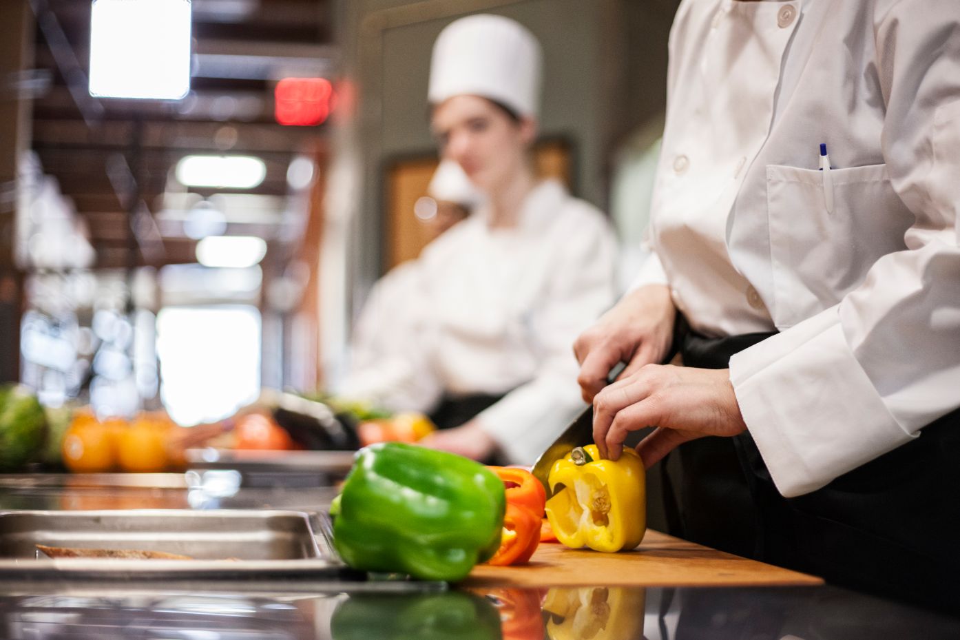 a closeup of the hands of a chef cutting vegetable CTNMW