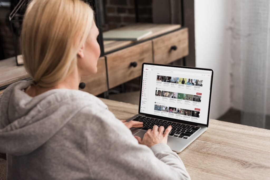 back view of woman using laptop