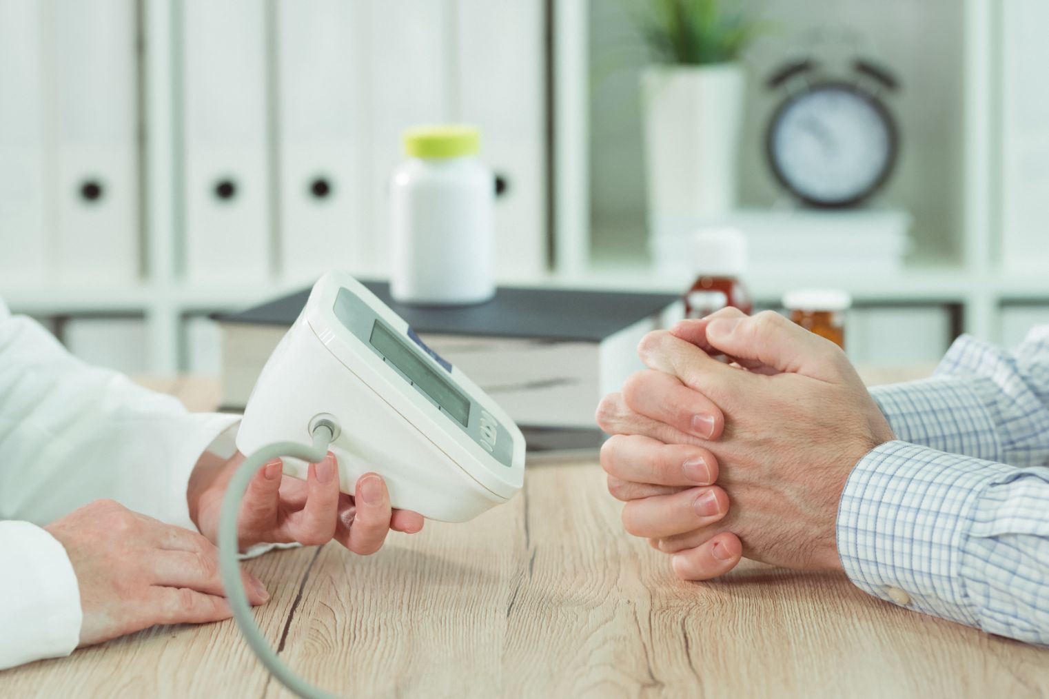 doctor and patient with digital blood pressure mon HRA