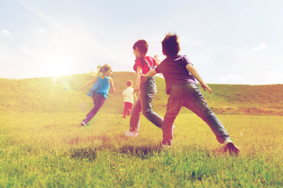 group of happy kids running outdoors PYKFDL