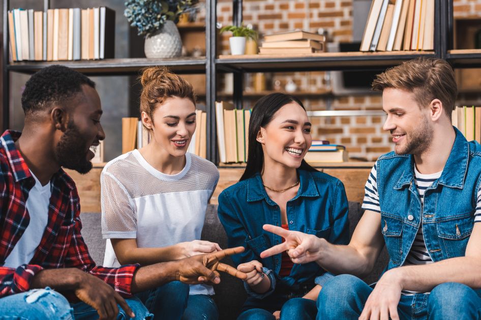 happy young multiethnic friends playing game of ro RYNW