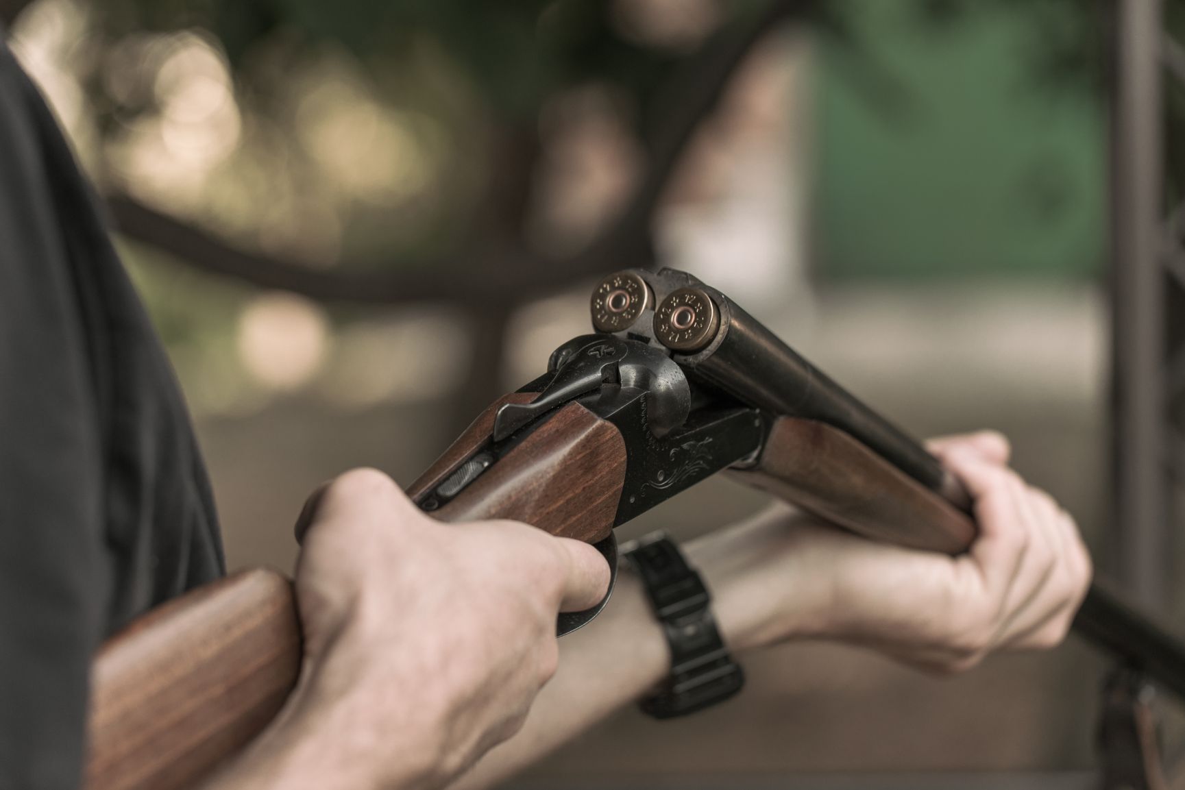 man charging double barreled hunting rifle closeup PNYD