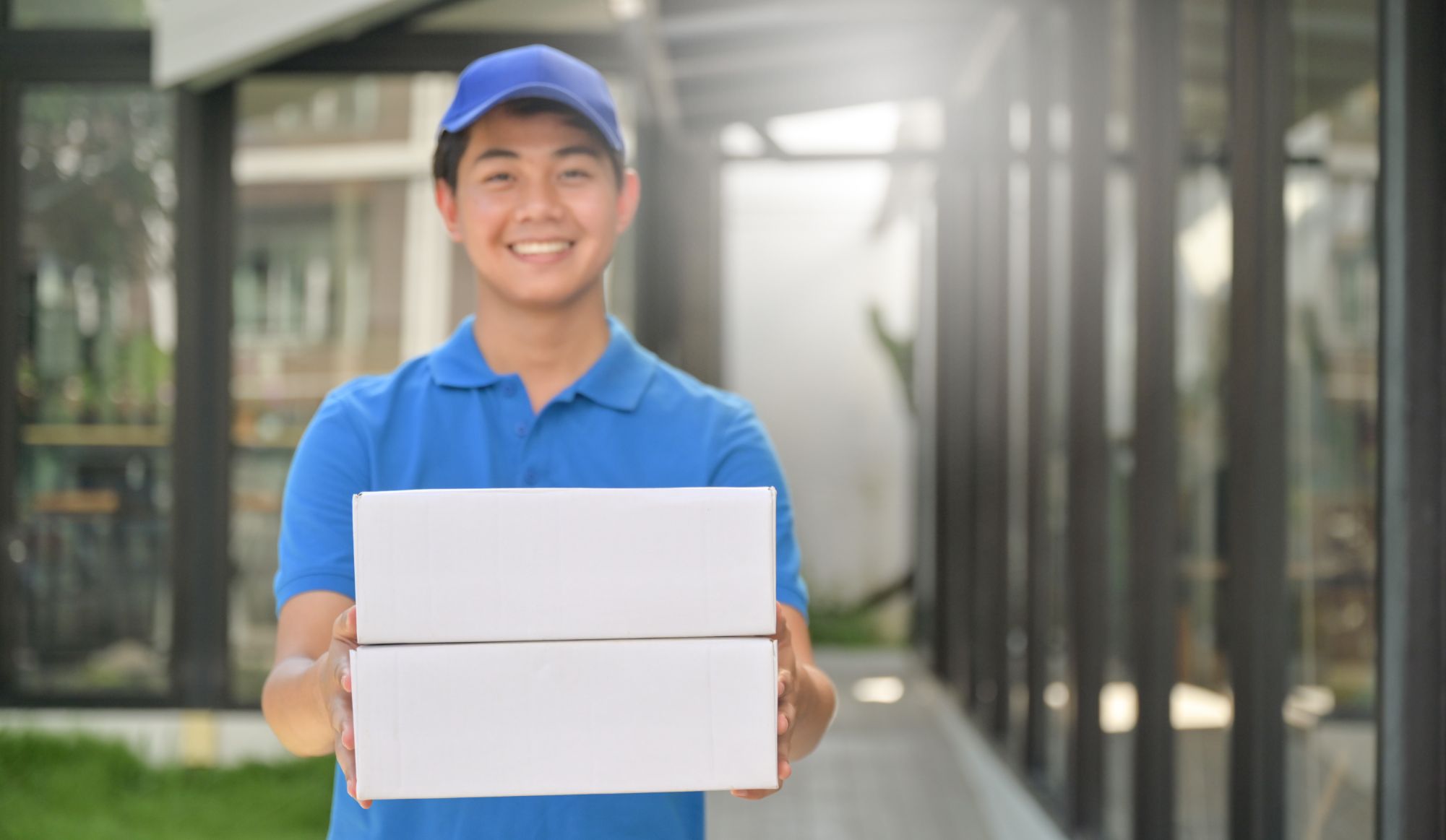 parcel delivery worker holding a box in hand ready HRVWCHZ