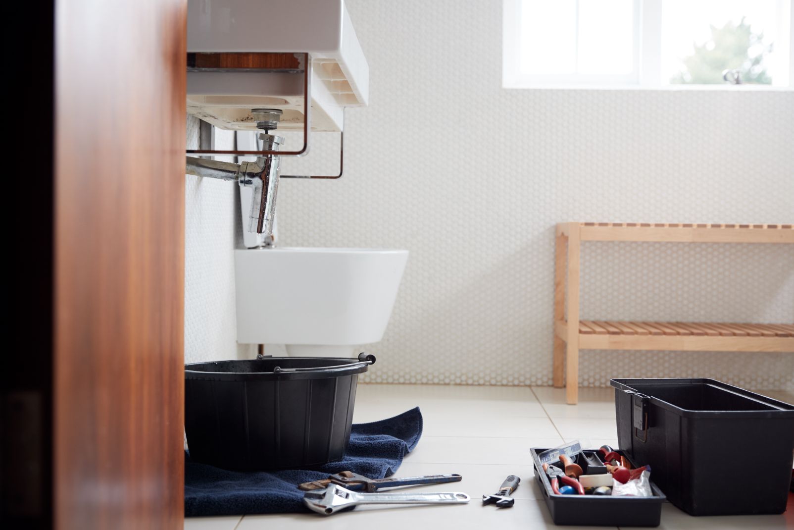 plumbing tools in bathroom ready to repair leaking QXZCX