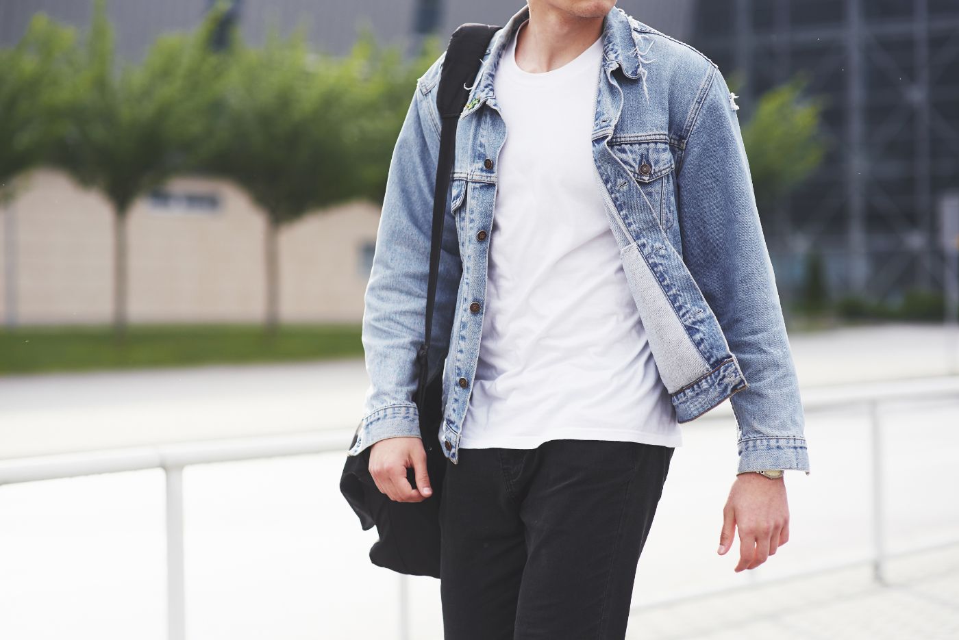young boy in a blue denim jacket on the street UWJGNM