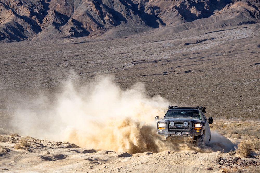 black suv on brown sand during daytime